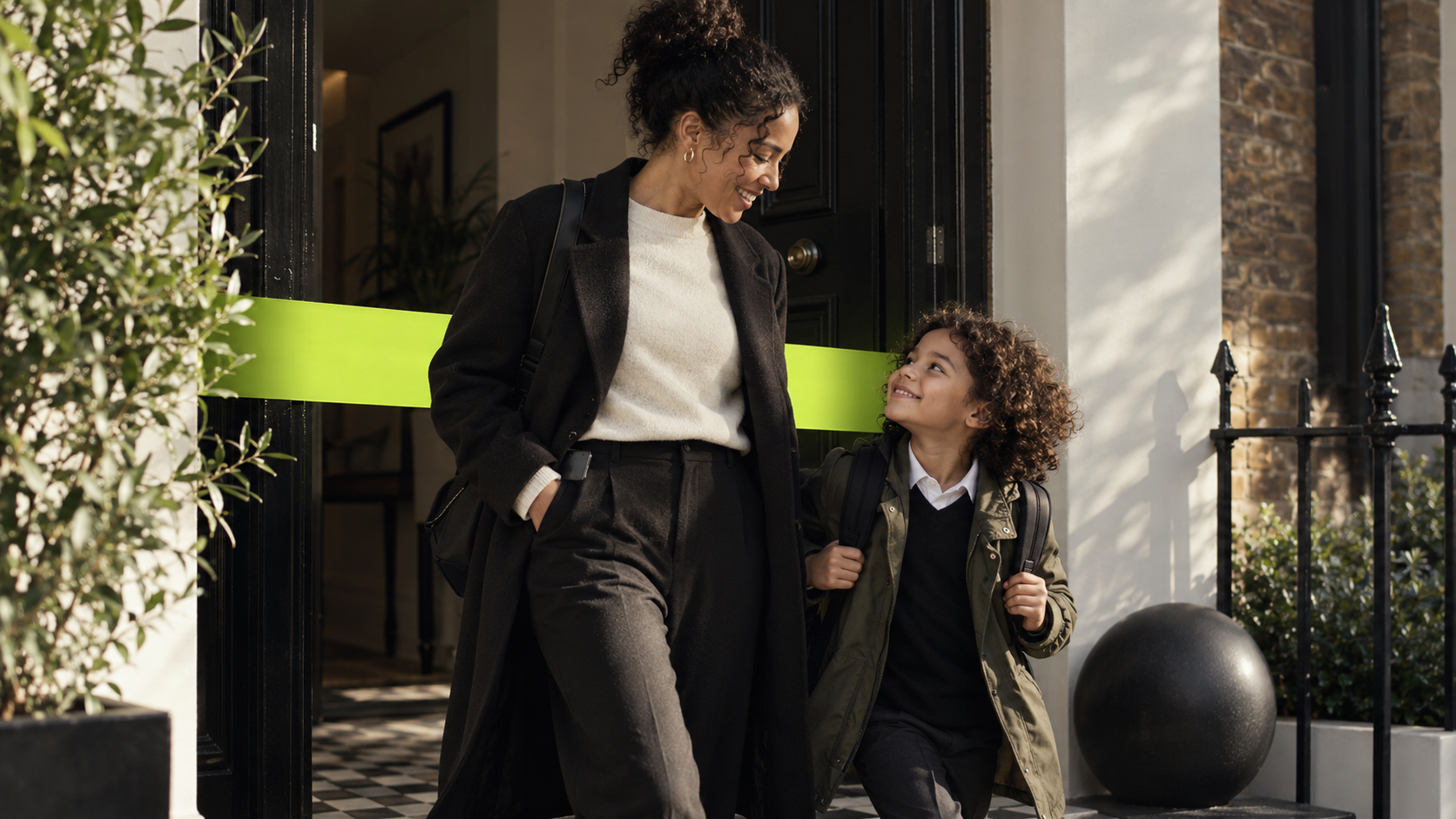 A parent and child leaving the house together on a school morning